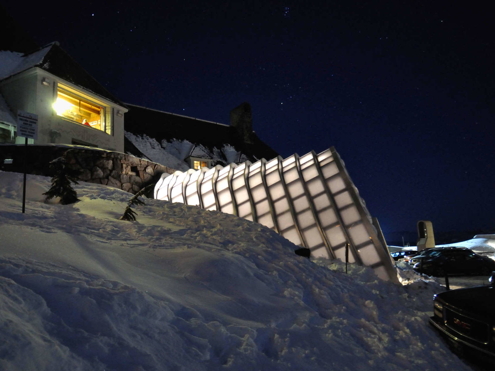 Winter Entrance modular sections appear to rest against the lodge's massive stone terrace like a wind blown snow drift