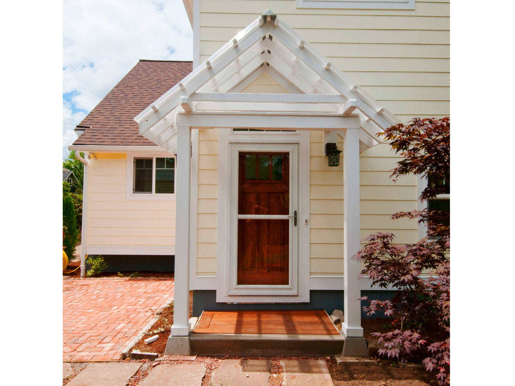 Covered back door and recycled chimney brick patio