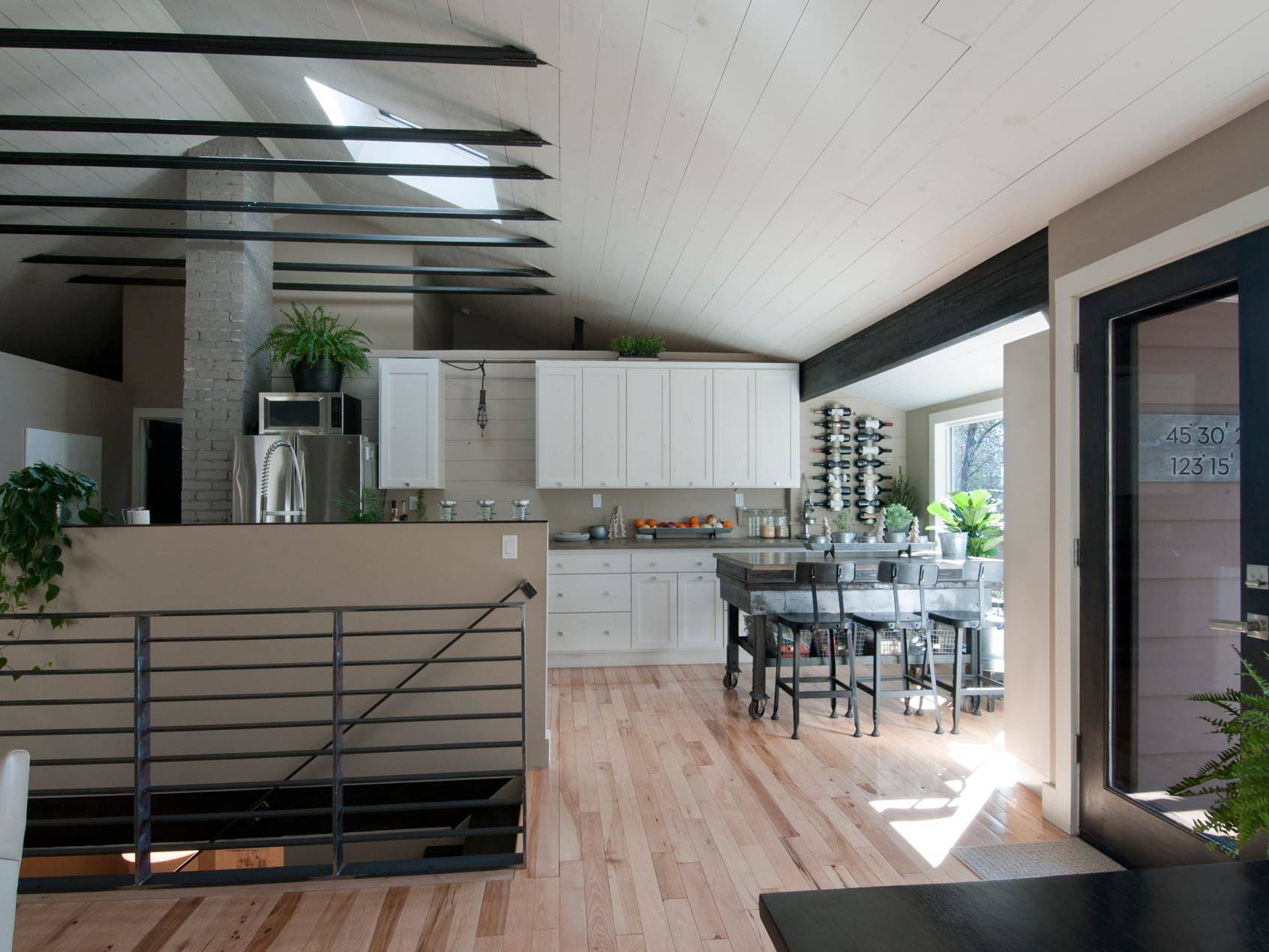 Mid-Century ranch renovation designed and engineered by rhiza A+D view of stair and kitchen